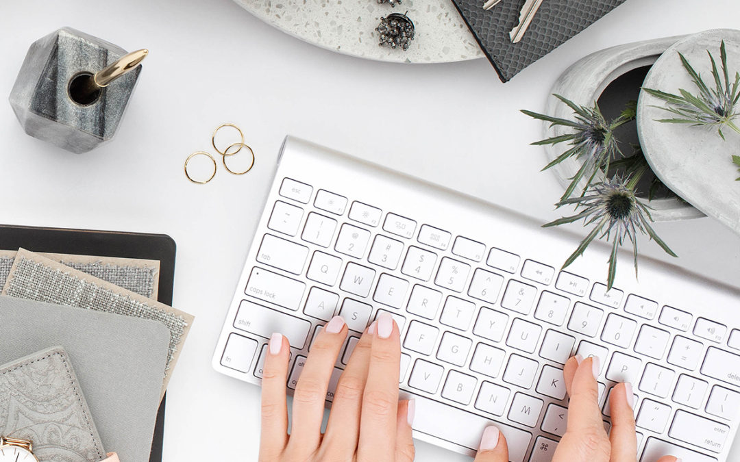 a woman's hands on a white keyboard